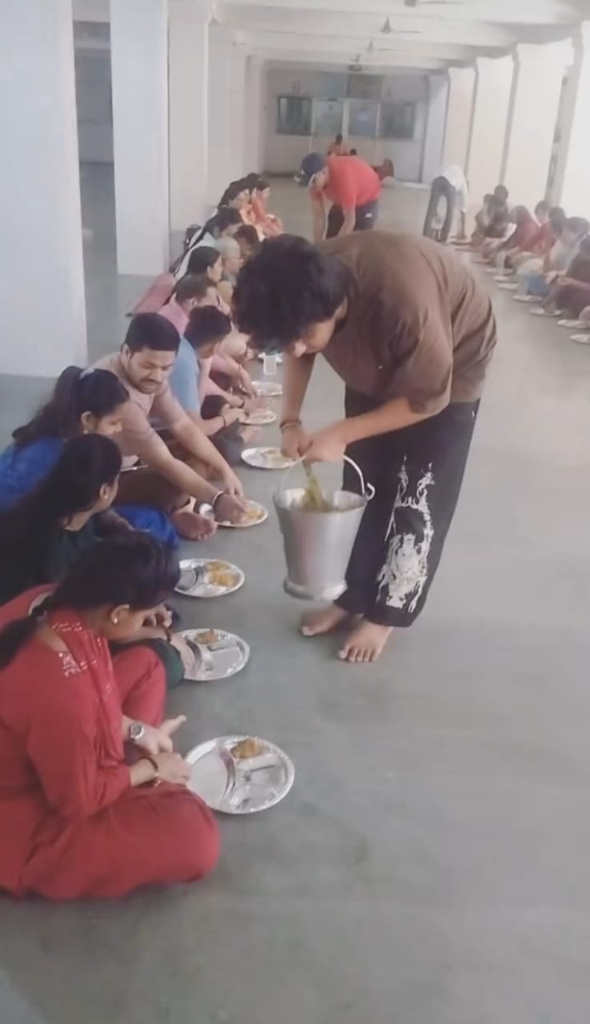Volunteers serving Bhandara food to devotees